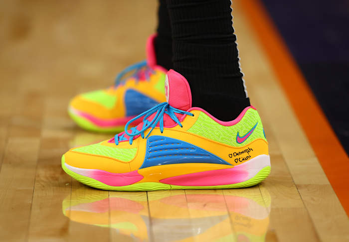 Brooklyn Nets forward Royce O'Neale's yellow and blue Nike KD sneakers.